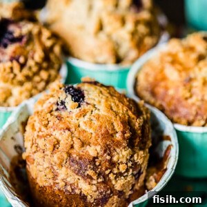 Gourmet Blackberry Burst Muffins 6 Detailed shot of a single bakery-style blackberry muffin, showcasing its golden crumb and streusel topping.