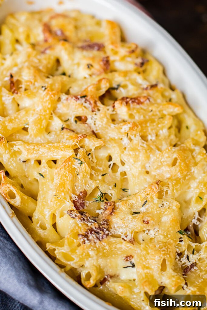 Smoky Bacon Brie Macaroni Bake 2 Close up of macaroni and cheese in a baking dish, highlighting the creamy texture and golden crust.