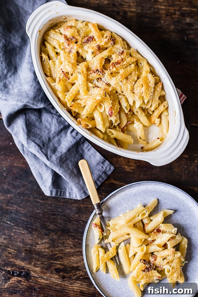Smoky Bacon Brie Macaroni Bake 3 A top-down view of a single serving of creamy macaroni and cheese on a plate.