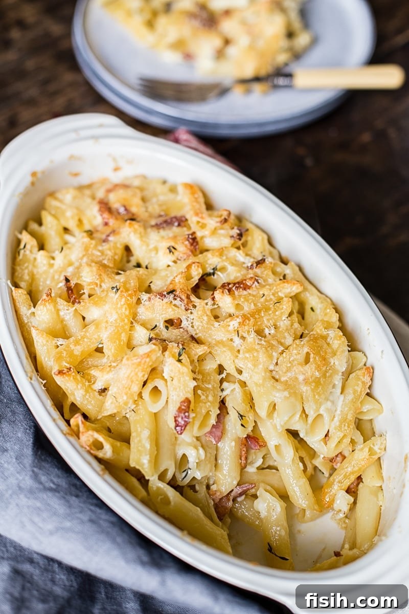 Smoky Bacon Brie Macaroni Bake 6 Close-up of a large baking dish filled with golden-brown Brie and Bacon Macaroni and Cheese.