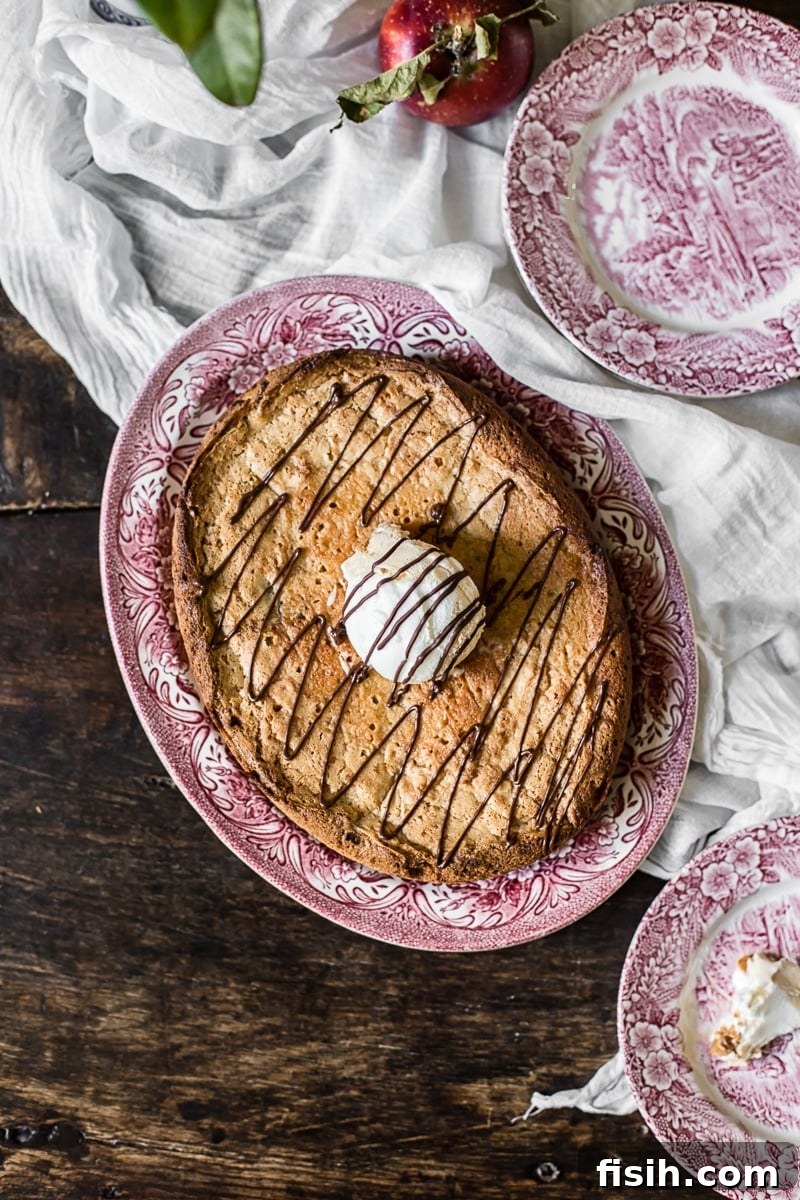 Irresistible Slow Cooker Chocolate Butterscotch Cookie Bars 3 Top-down view of a single slice of a chocolate butterscotch cookie bar on a white plate, highlighting its rich, marbled texture and molten center.