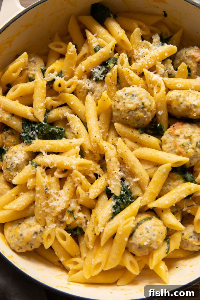 top down view of penne pasta with creamy pumpkin sauce and homemade sausage meatballs