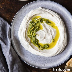 Close-up of the whipped feta and ricotta dip with mint pistachio pesto, ready to be served.