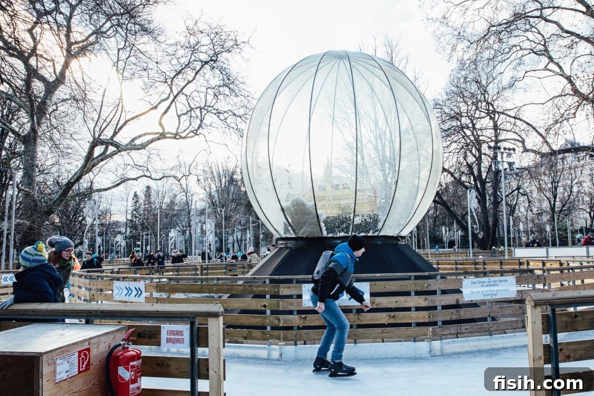 Skater enjoying the ice rink and a giant snowglobe at Rathausplatz Christmas Market