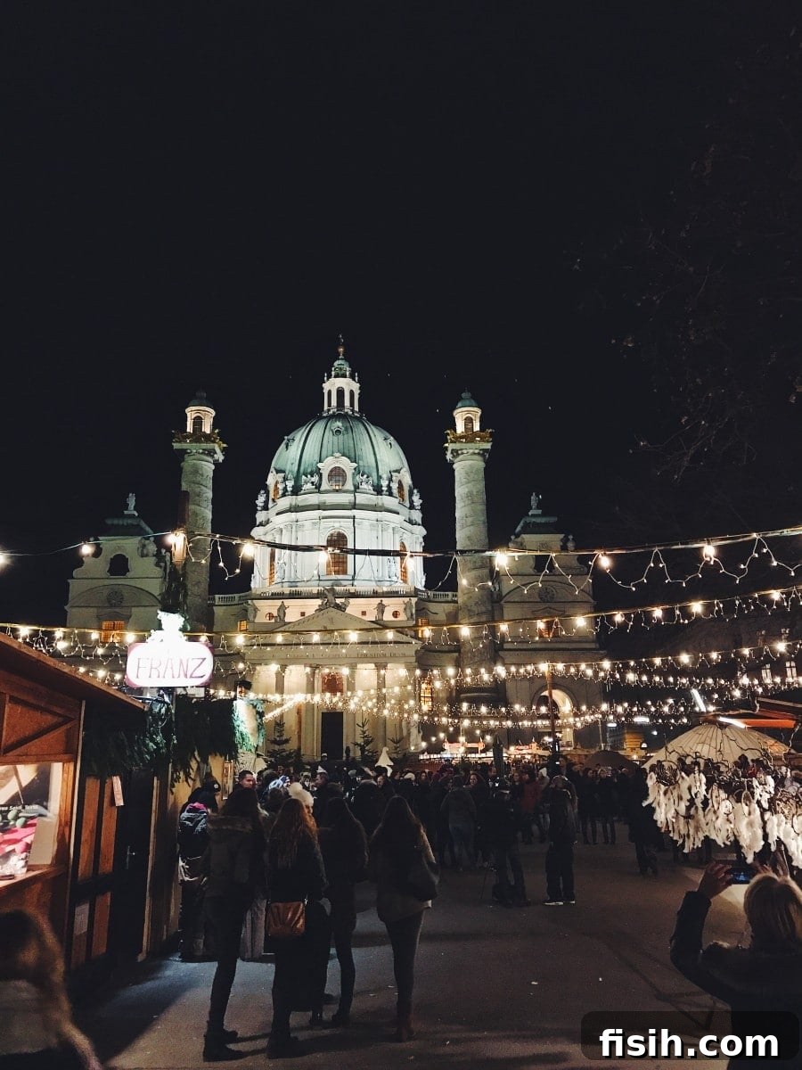 Christmas market at Karlplatz, bustling with visitors and festive lights