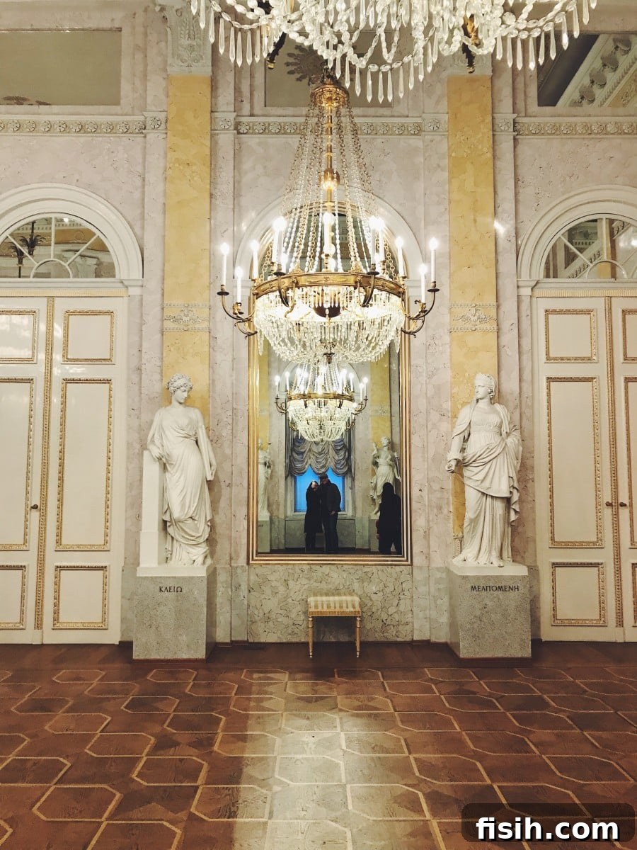 Elaborate chandeliers and statues in a palace hall at Schonbrunn