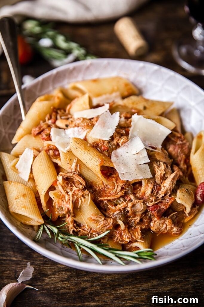 Braised Venetian Chicken Ragu Pasta 2 A generous bowl of Venetian Chicken Ragu pasta topped with fresh cheese shavings, inviting and rustic.