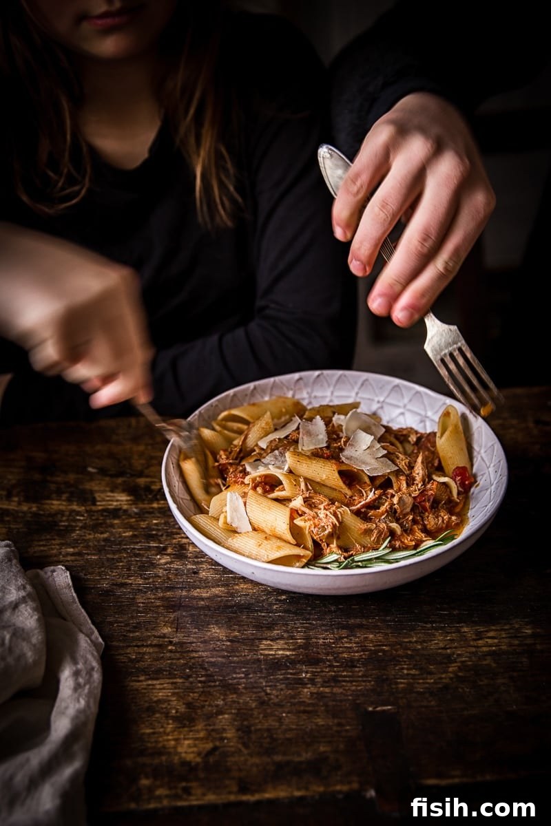 Braised Venetian Chicken Ragu Pasta 6 Hands delicately reaching for portions of the Venetian Chicken Ragu dish with forks, ready to savor the meal.