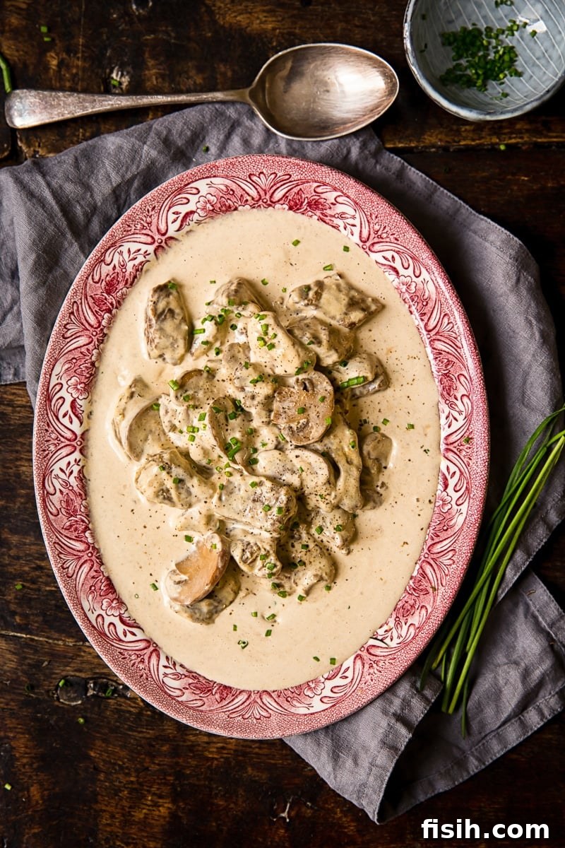 Serving plate of beef in creamy truffle sauce, garnished