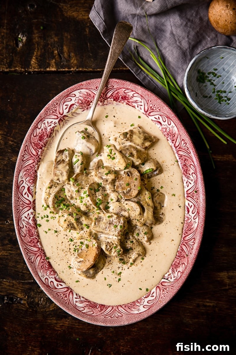 Top down view of a serving platter with the beef in truffled cream sauce meal