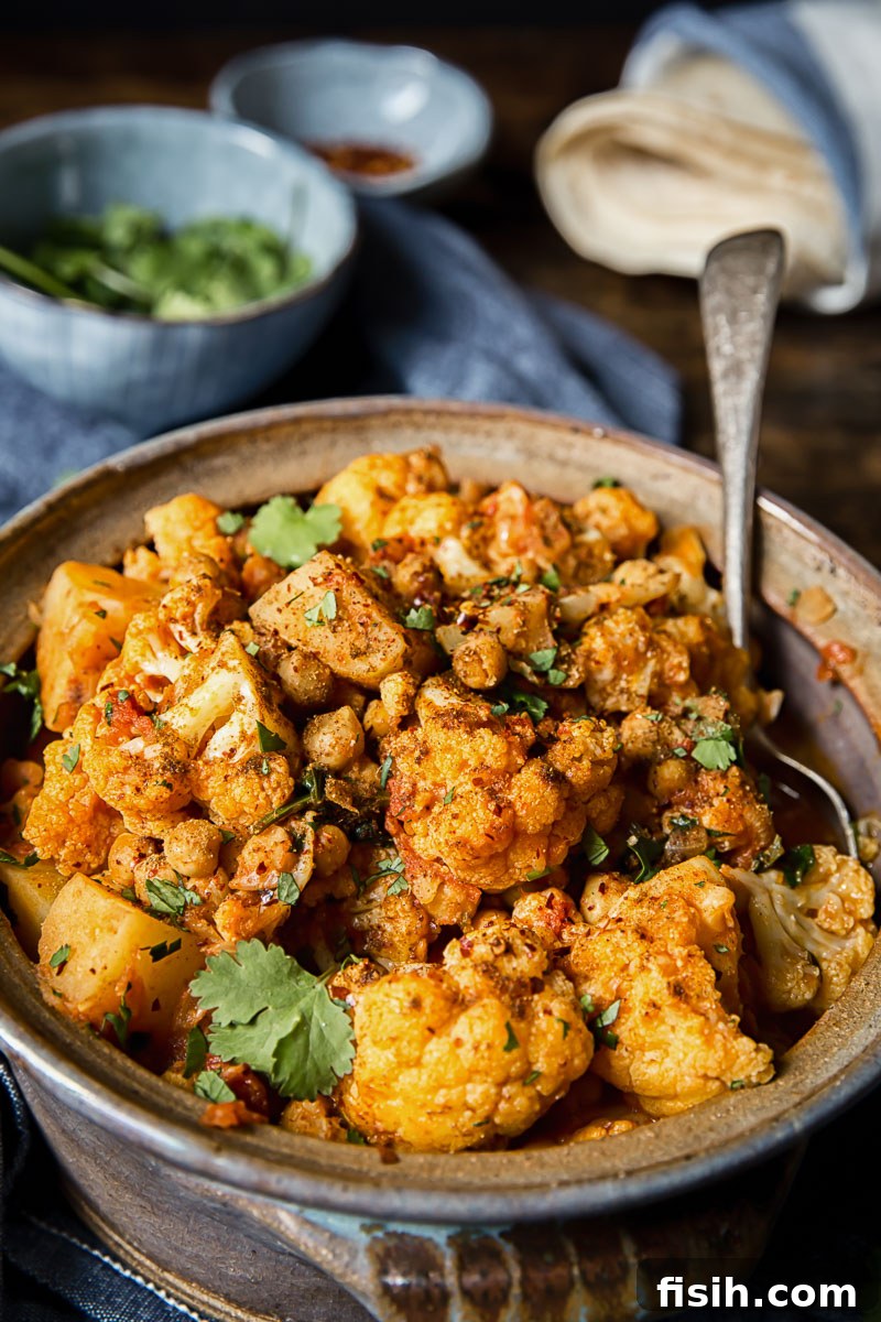 close up of cauliflower and potato curry in a clay pot