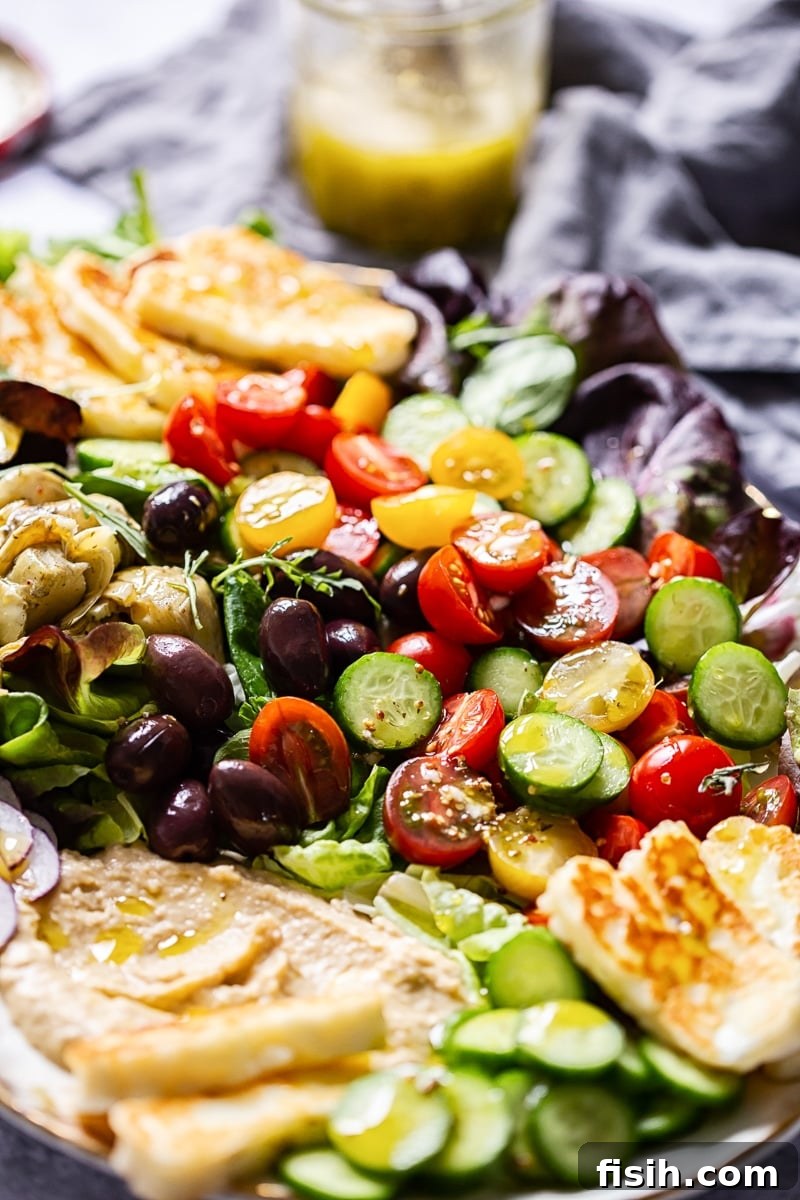 Golden Halloumi & Hummus Mediterranean Salad 4 Close up of Mediterranean salad on a plate, highlighting the fresh ingredients.