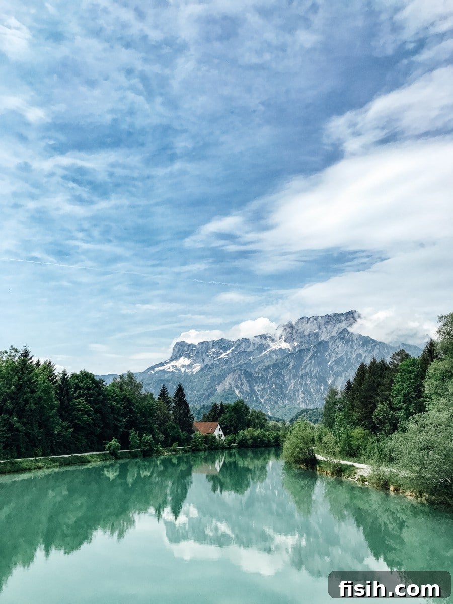 Lush green mountains and a pristine river winding through a valley near Salzburg, Austria