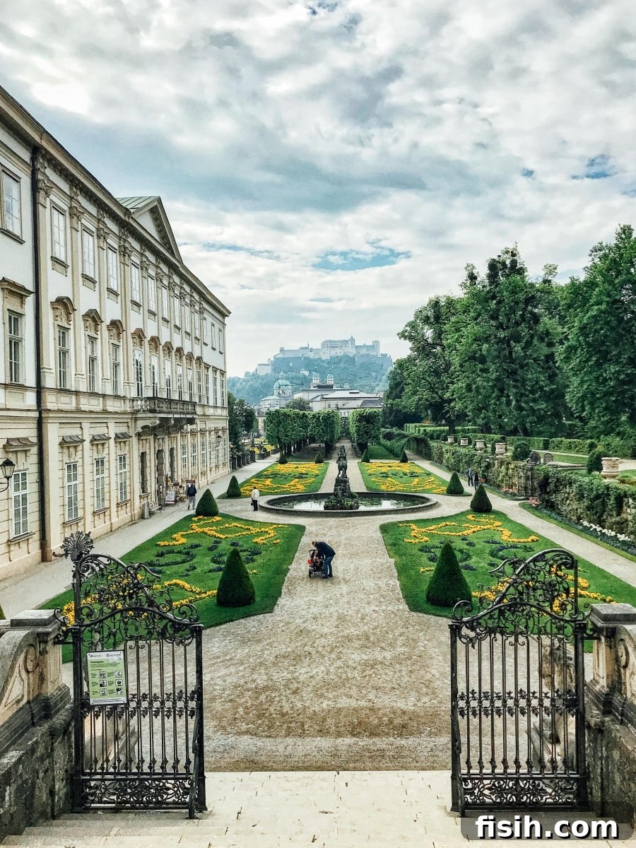 View of Mirabell Gardens, with its ornate fountains and sculptures, and the Hohensalzburg Fortress in the distant background