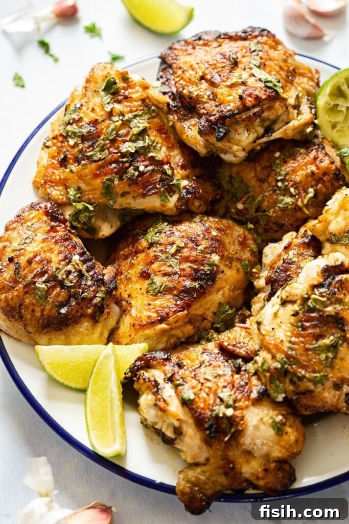 Plate of chicken with lime slices, garnished with fresh mint