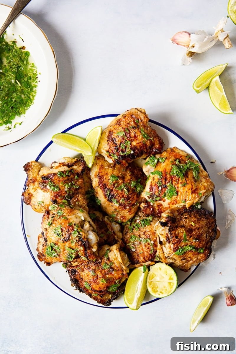 Top-down view of a plate of mojito grilled chicken thighs, beautifully arranged.