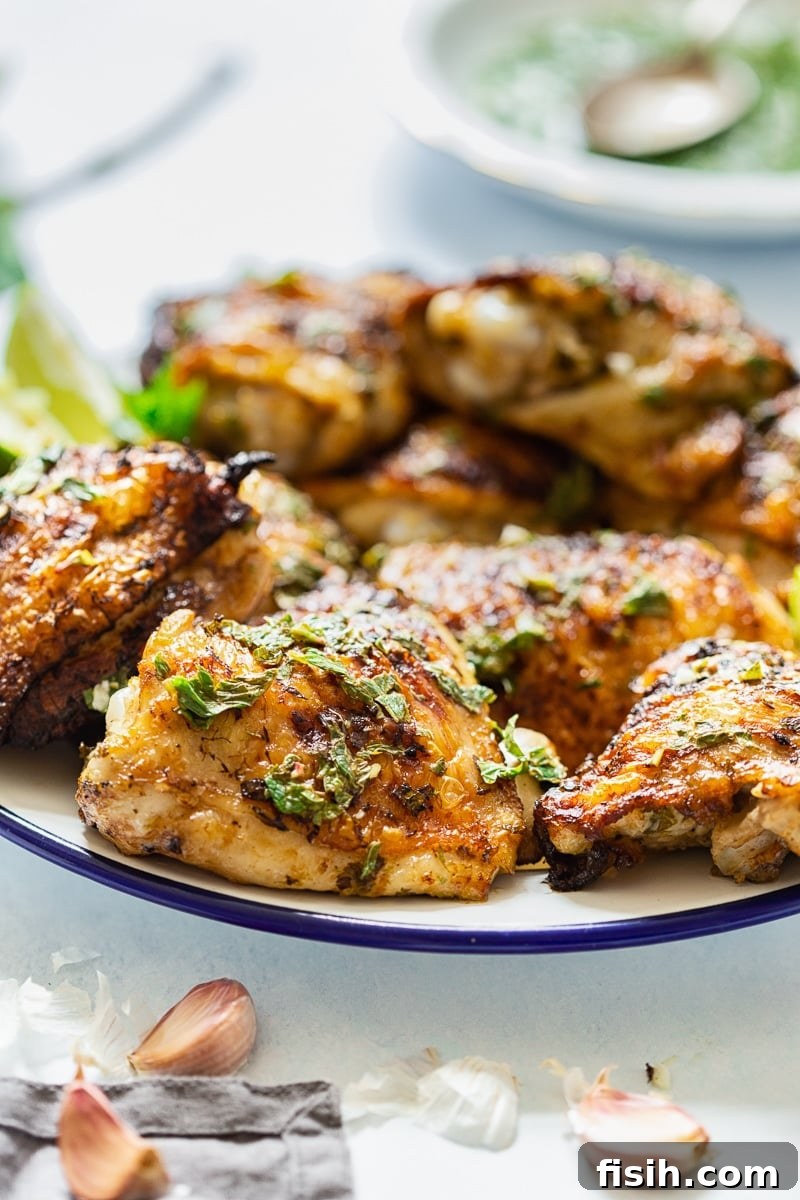 Grilled chicken on a white plate, ready to be served