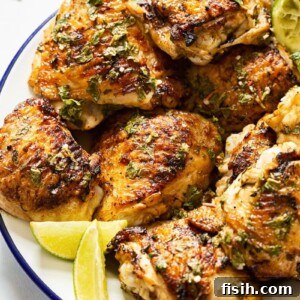 Plate of chicken with lime slices, garnished with fresh mint