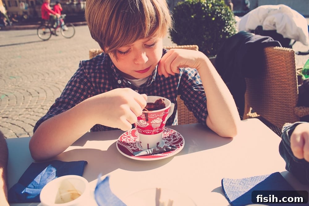Close-up of a child enjoying a warm beverage during a family trip