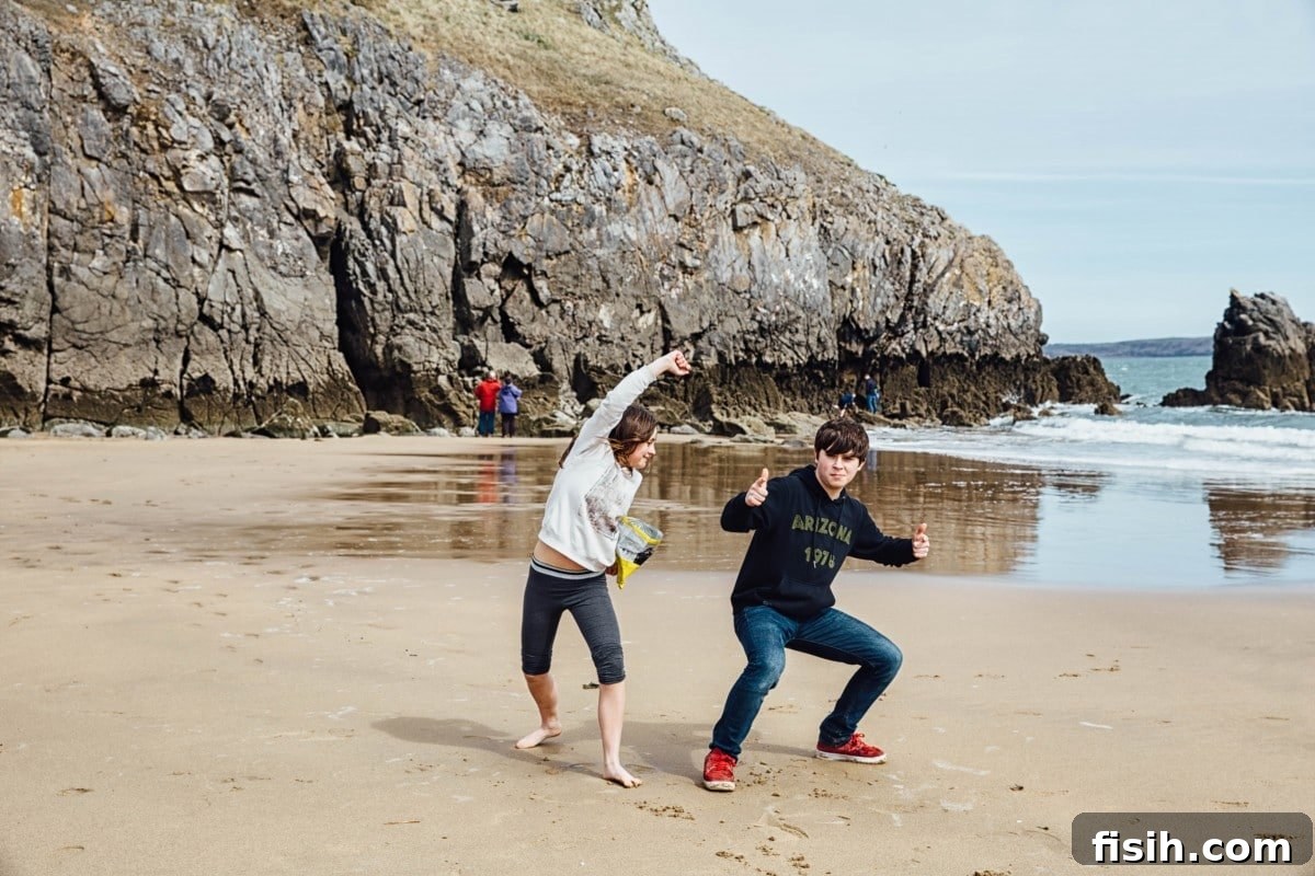 Children playing joyfully on a beautiful sandy beach in Wales