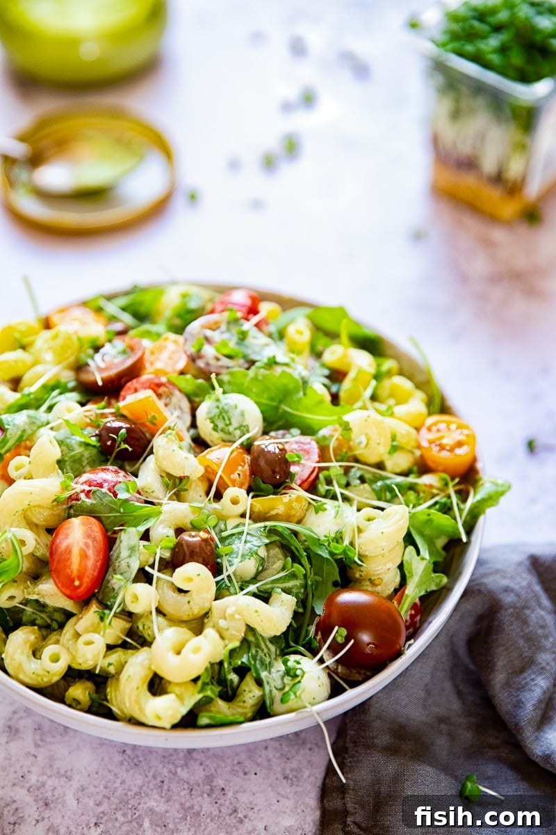 A beautiful bowl of Green Goddess Pasta Salad, garnished and ready for serving.