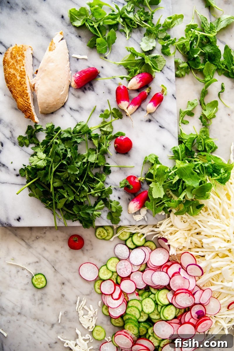 Creamy Keto Cabbage Slaw 5 Assortment of fresh salad ingredients spread across a marble table