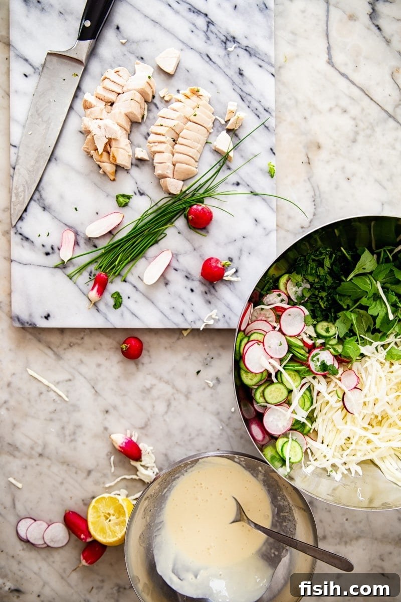 Creamy Keto Cabbage Slaw 7 Fresh ingredients in a bowl and on a chopping board, ready for preparation