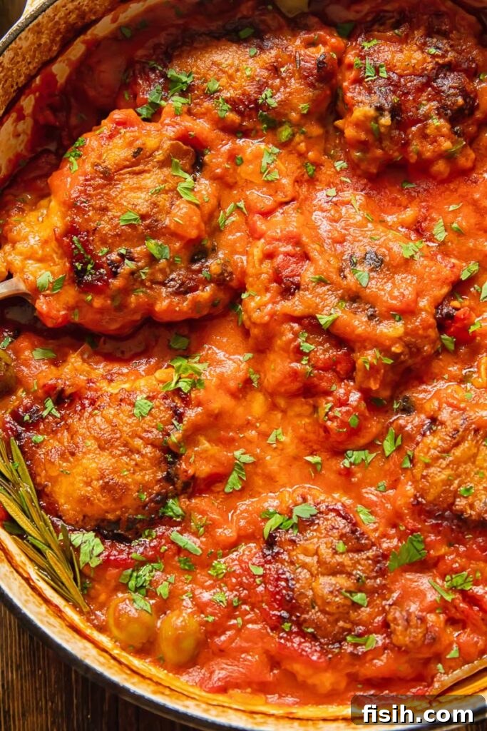 close up photo of the cacciatore sauce with fresh parsley sprinkled on top, highlighting the rich texture