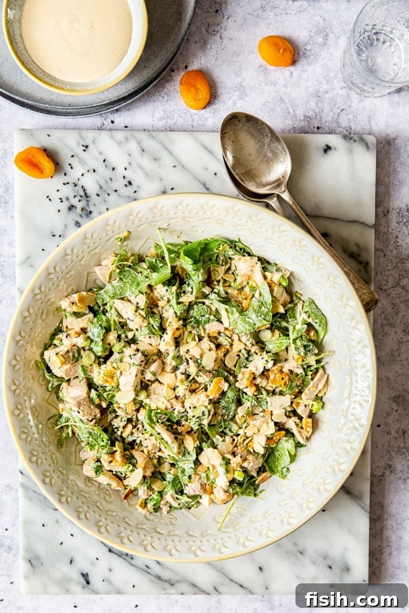 top down view of the salad next to spoons and apricots