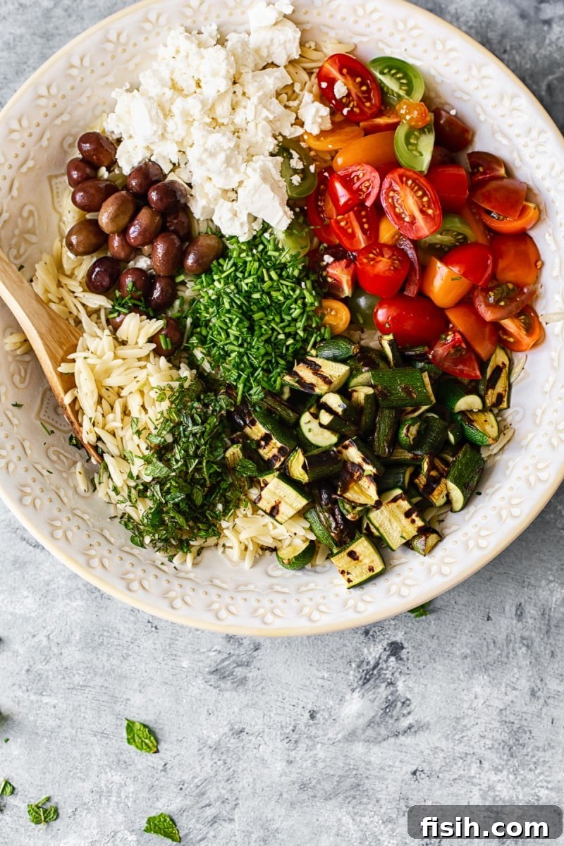 Mediterranean Orzo Salad with Grilled Zucchini 5 Overhead view of a prepared Greek Orzo Salad in a large bowl, ready to serve.