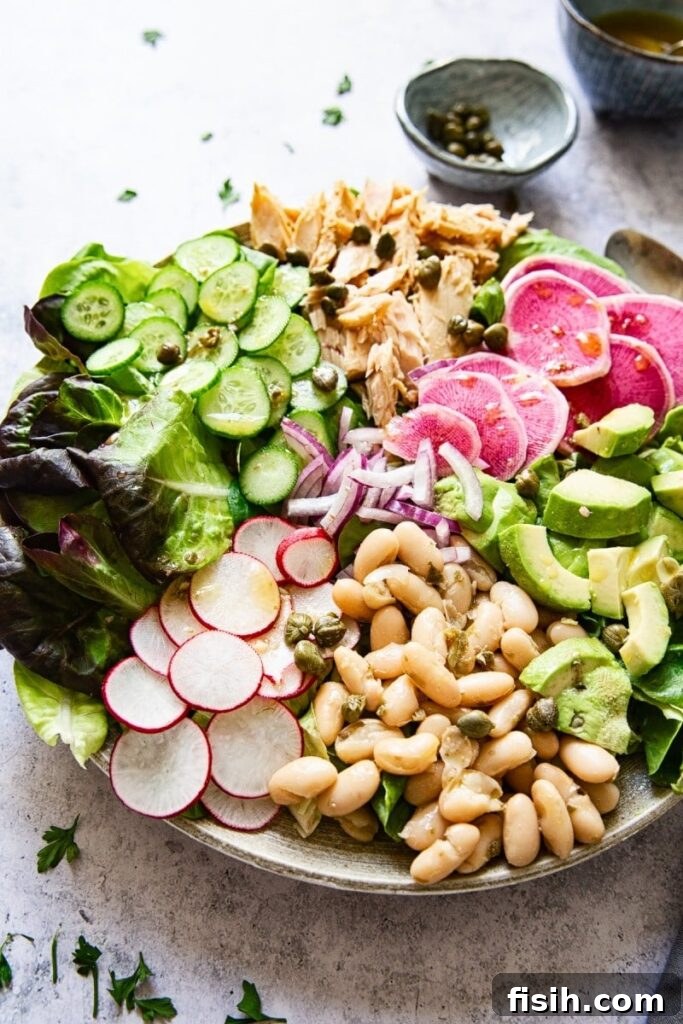 Healthy Italian Tuna Salad in a bowl, garnished with fresh herbs and vegetables