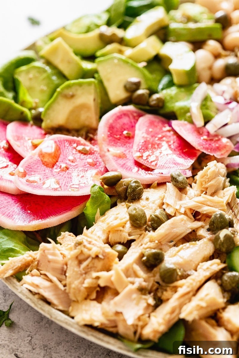 Close-up of the healthy tuna salad showcasing flaked tuna, vibrant radishes, and green vegetables
