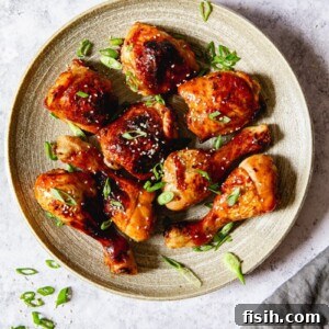 top down view of chicken thighs and legs sprinkled with green onions