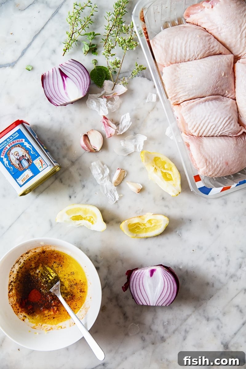 Overhead view of all the fresh ingredients laid out for the Spanish baked chicken recipe