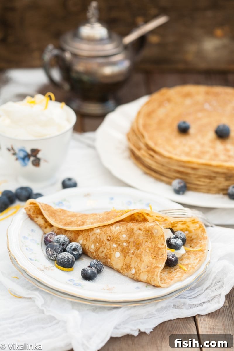 Delightful cheese blintzes, golden brown and ready to be filled, served on a elegant platter.