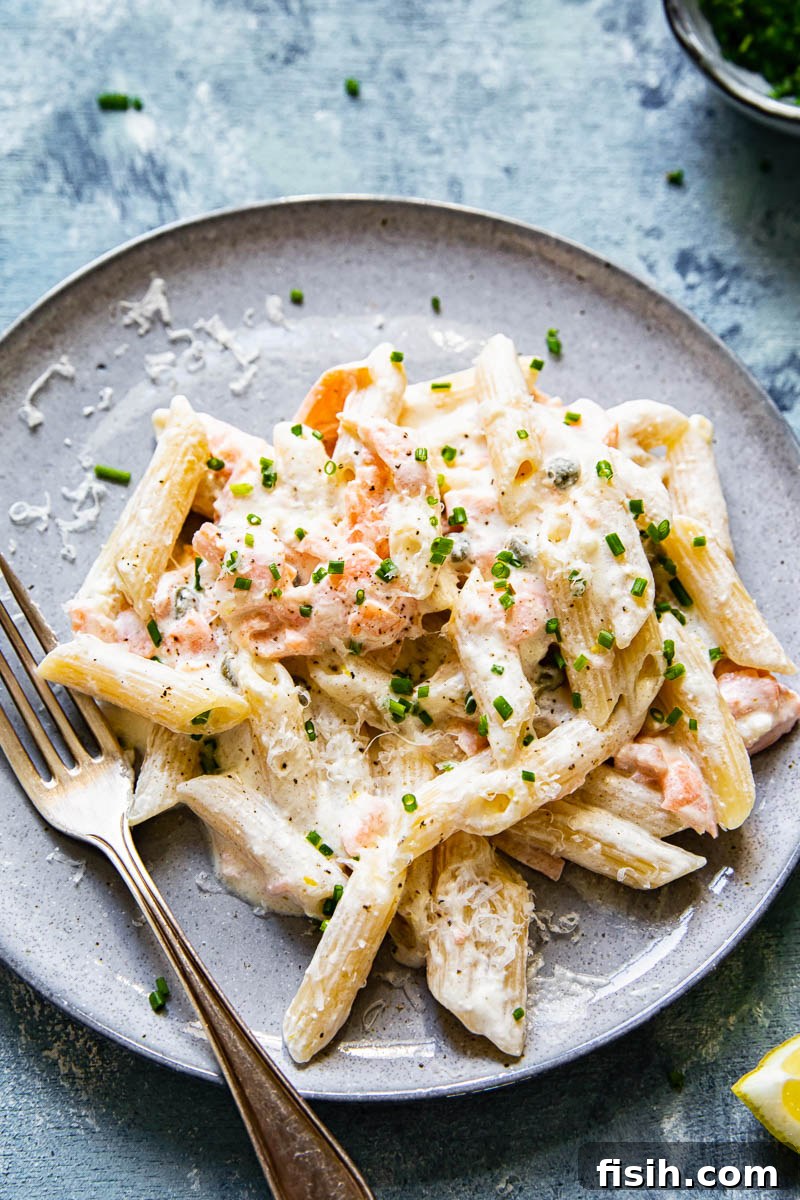 Close up of creamy pasta with smoked salmon, showing the rich sauce and flaky fish