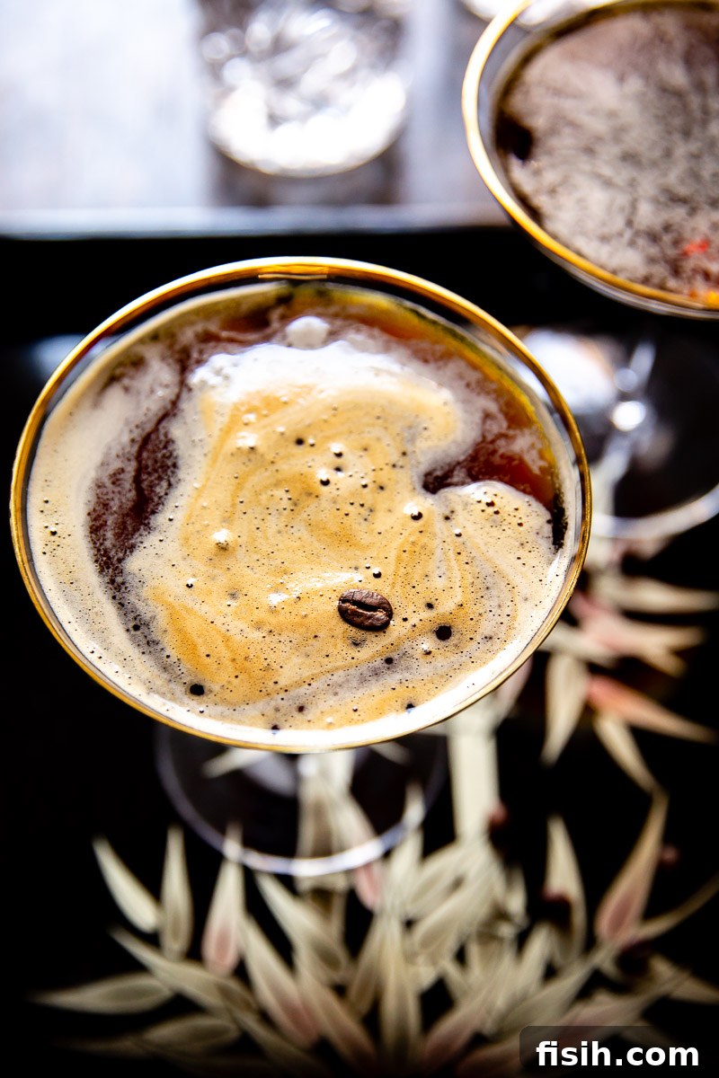 An Espresso Martini viewed from above, garnished with three coffee beans.