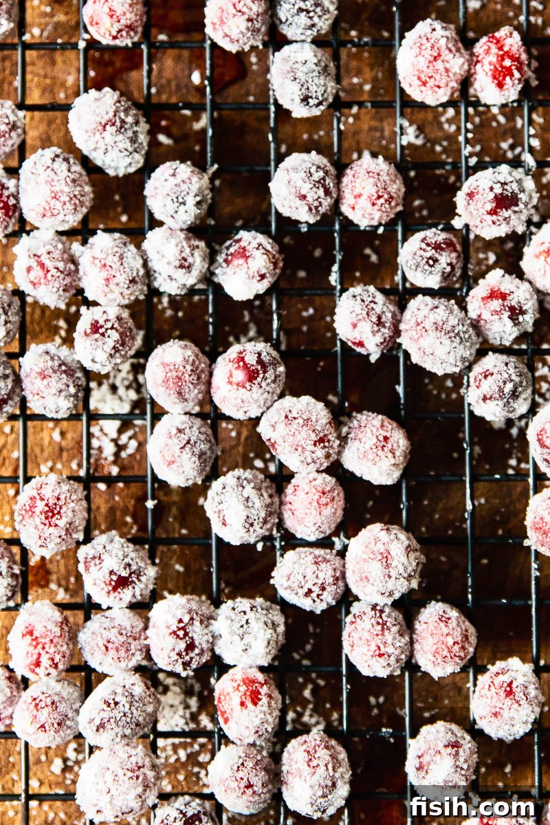 Sugared cranberries drying on a wire rack, ready for decoration