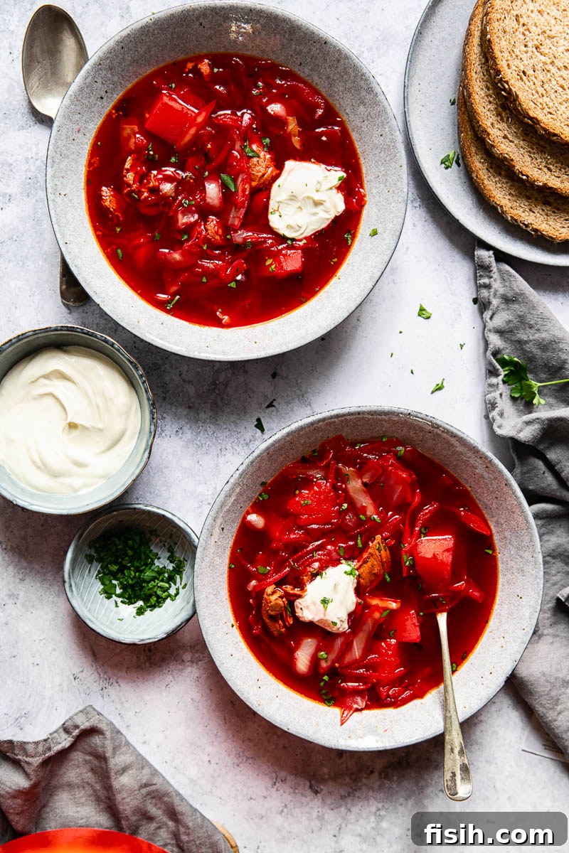 Heartwarming Borscht Made Easy 8 top down of two bowls of borscht with sour cream and parsley