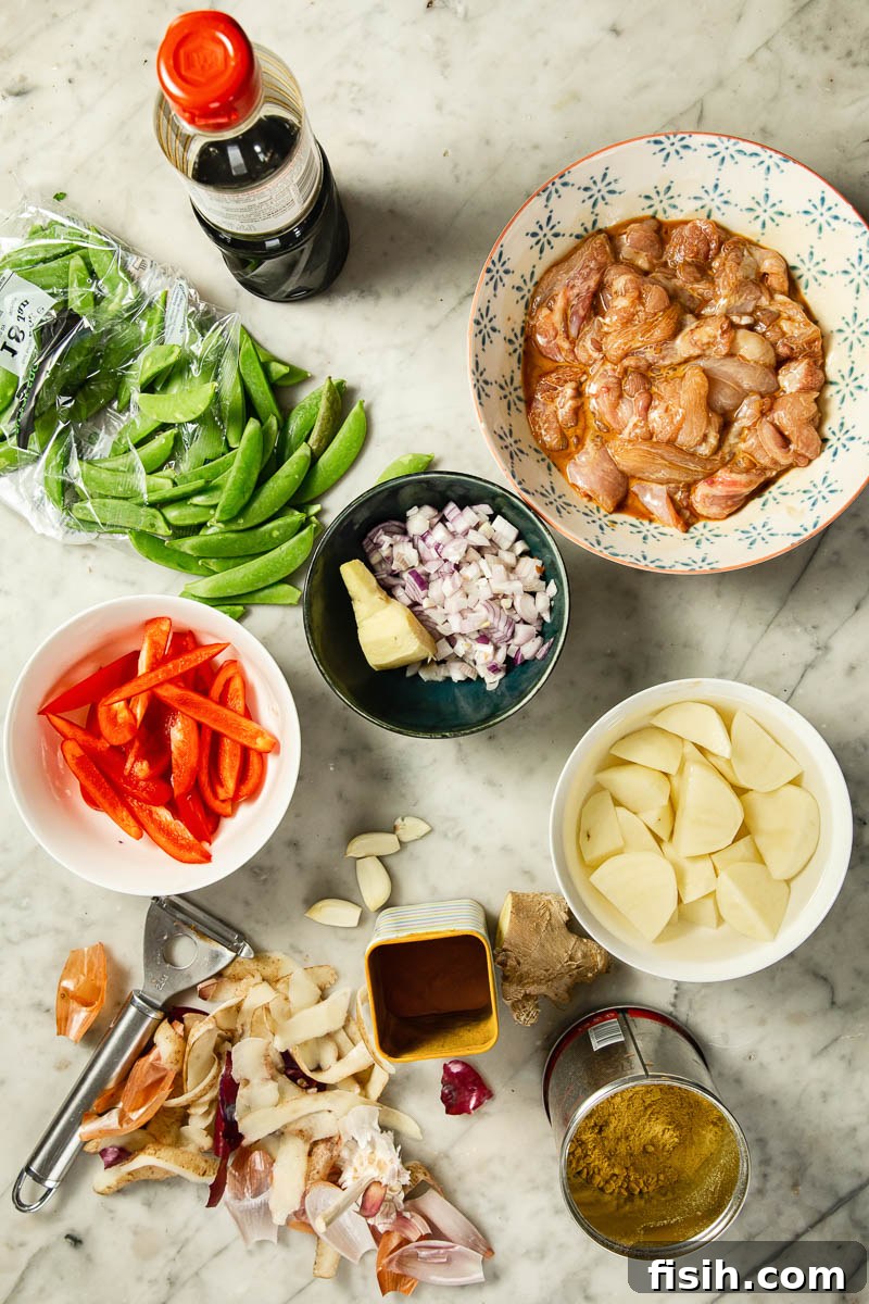 Golden Goodness Homemade Chinese Chicken Curry 4 Fresh ingredients laid out for Chinese chicken curry preparation: chicken, vegetables, and spices