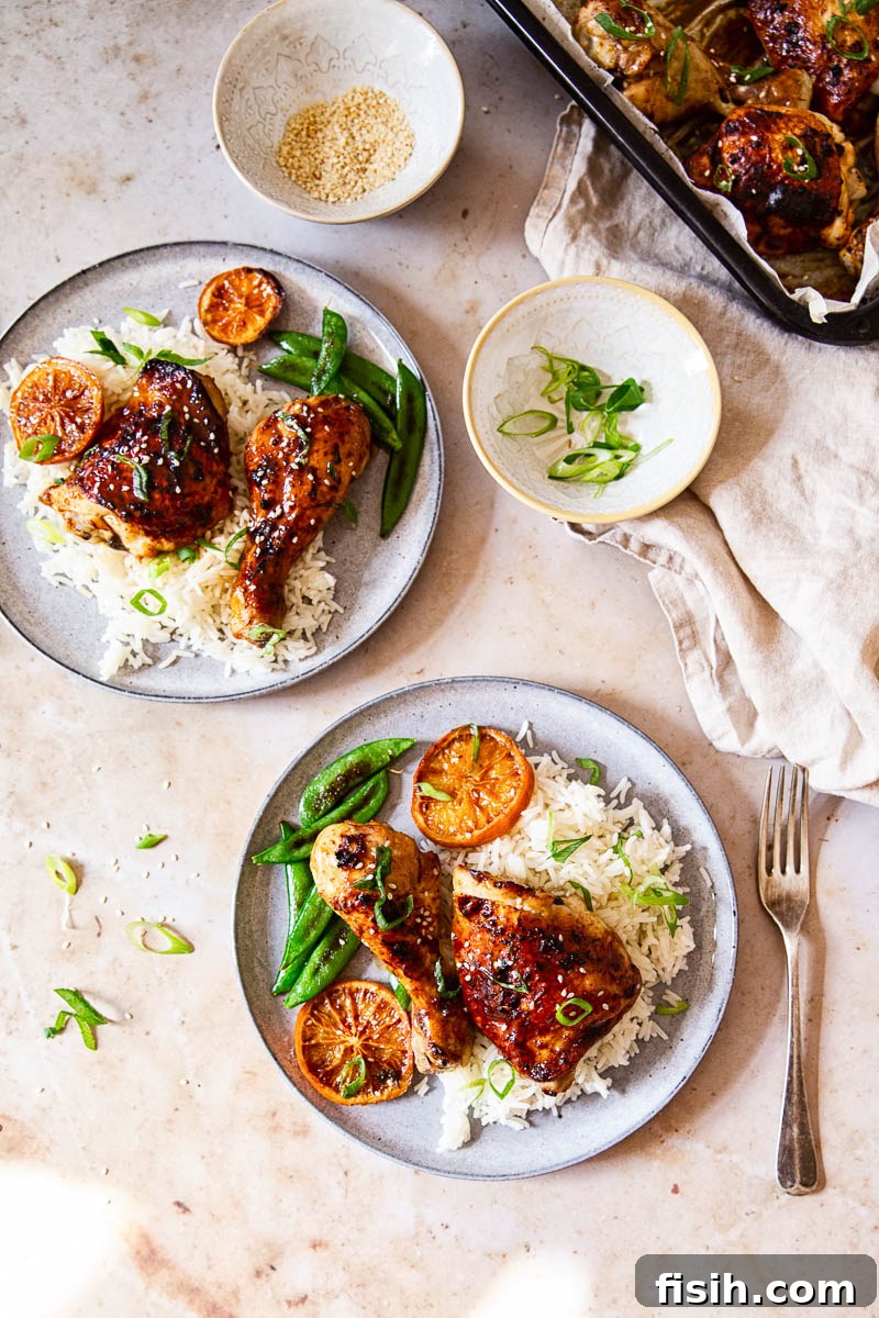 Sweet and Sticky Oven-Baked Chicken Thighs and Drumsticks 3 Perfectly baked honey soy chicken thighs and legs with flavorful crispy skin and a sticky glaze served over white rice with sugar snap peas, scallions and sesame seeds.