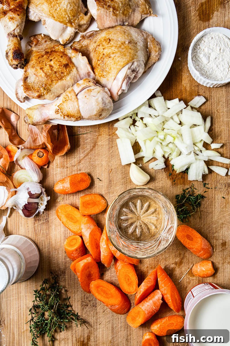 Ingredients for Creamy Chicken Casserole laid out on a wooden board.