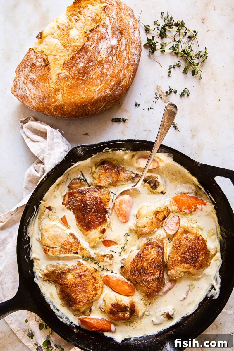 A serving of creamy chicken casserole in a bowl, garnished with fresh herbs.