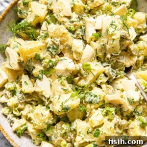 top down view of potato salad with dill and green onions
