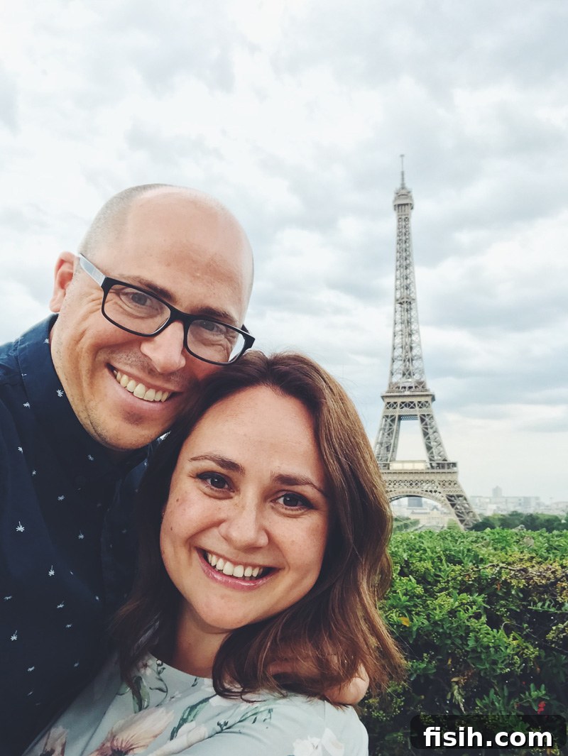 Brad and Julia smiling in front of the iconic Eiffel Tower