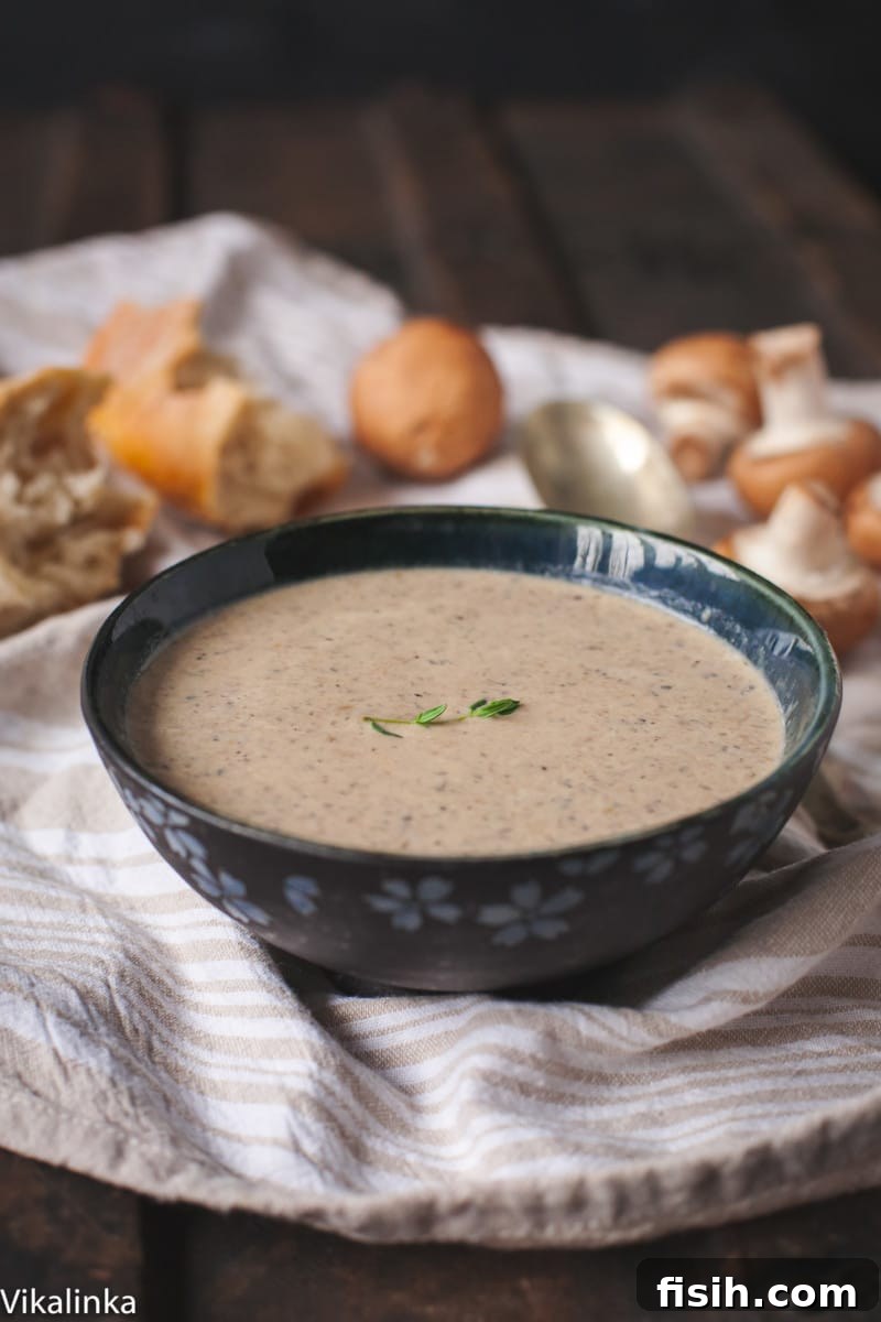 A simple, elegant bowl of creamy mushroom soup, ready to be enjoyed as a comforting and delicious meal, highlighting its smooth texture.