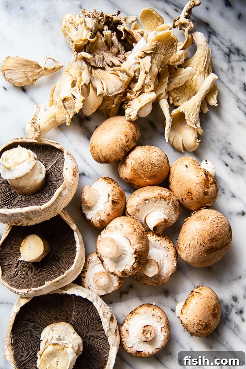 A mix of raw mushrooms on marble