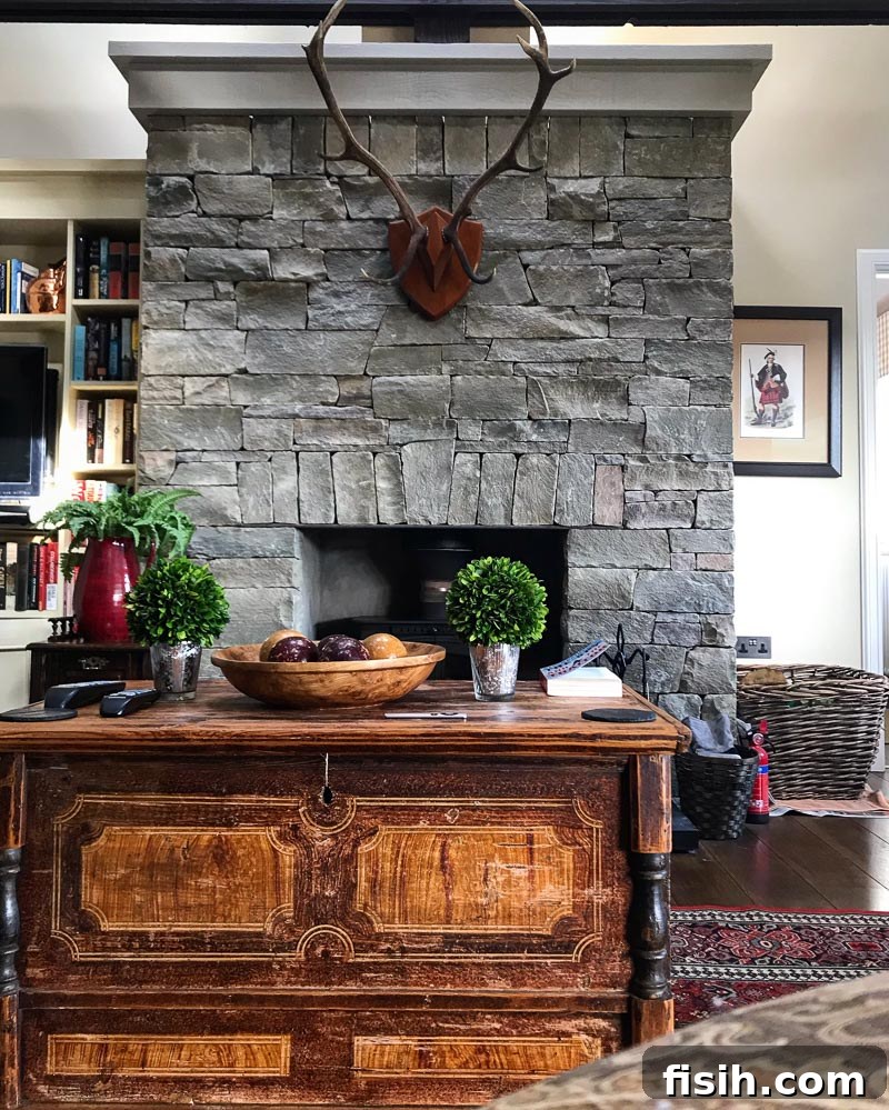 Unveiling Mull's Island Magic 6 Elegant interior of a spacious living room with a stone fireplace, comfortable sofa, and large windows.