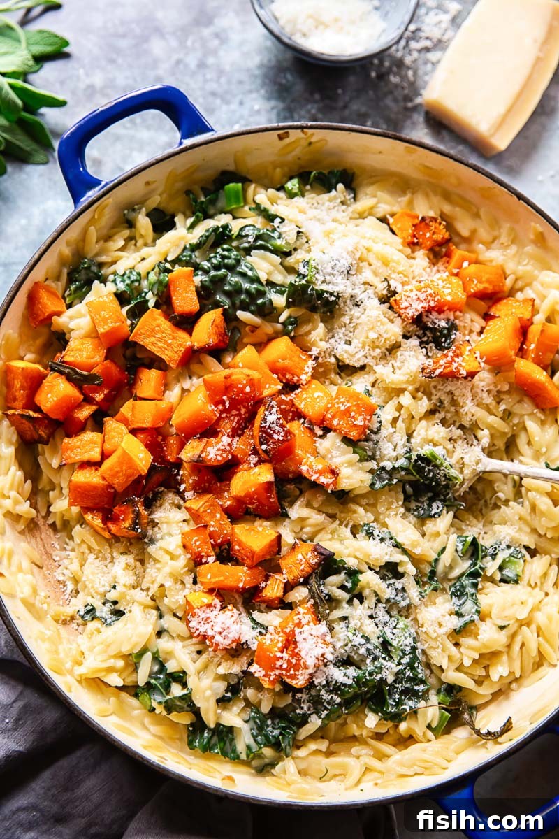 Golden Butternut and Creamy Orzo 2 A close-up shot of creamy butternut squash orzo pasta, garnished with fresh sage leaves and grated Parmesan cheese, in a bowl, capturing the rich texture and vibrant colors of this autumn dish.