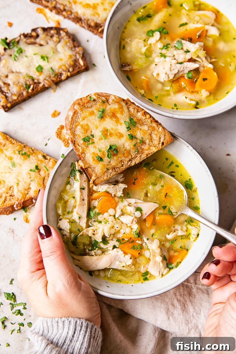 Hands holding a bowl plus cheesy toast